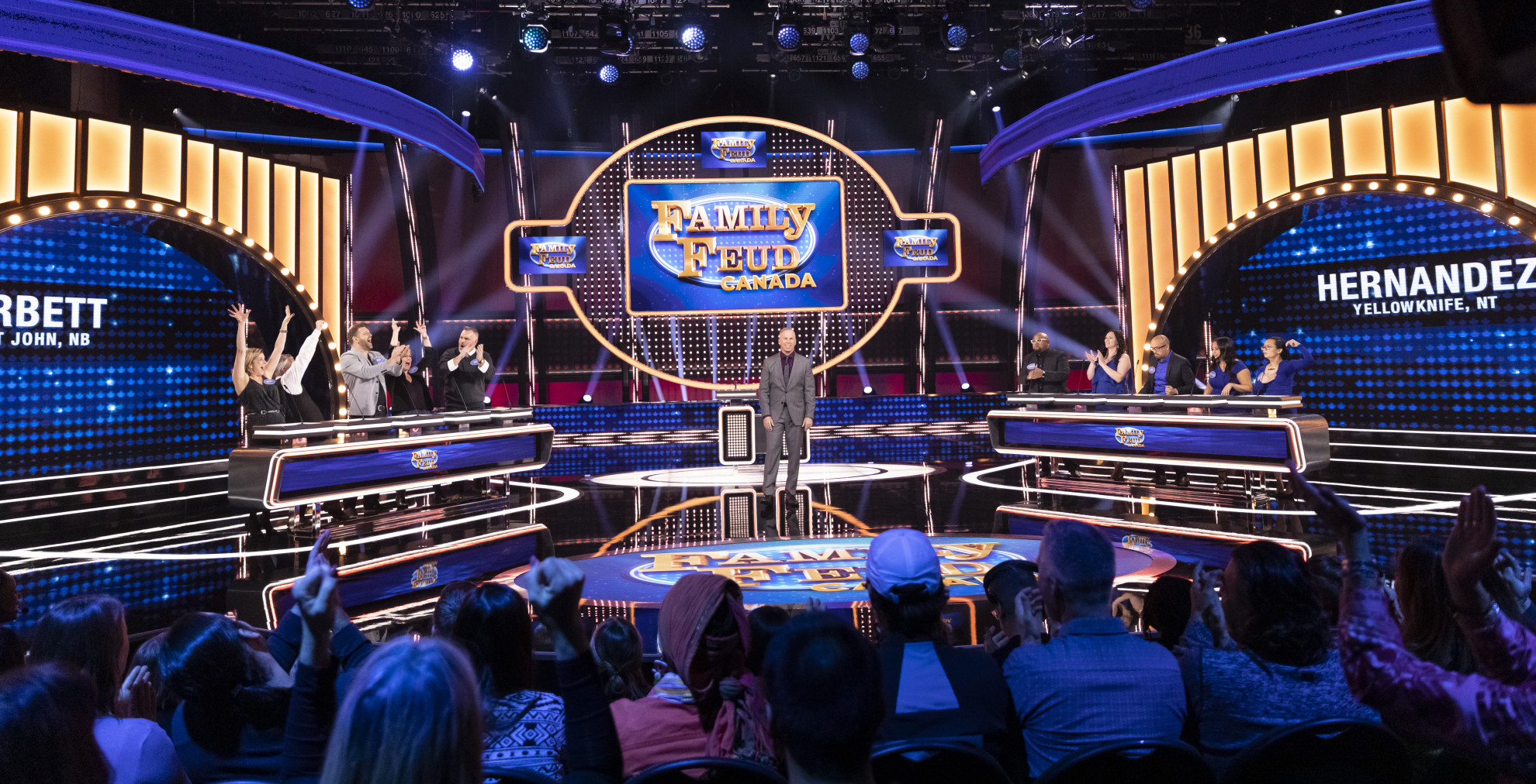 Corbett (New Brunswick) and Hernandez (Northwest Territories) families get ready to play Family Feud Canada with host Gerry Dee